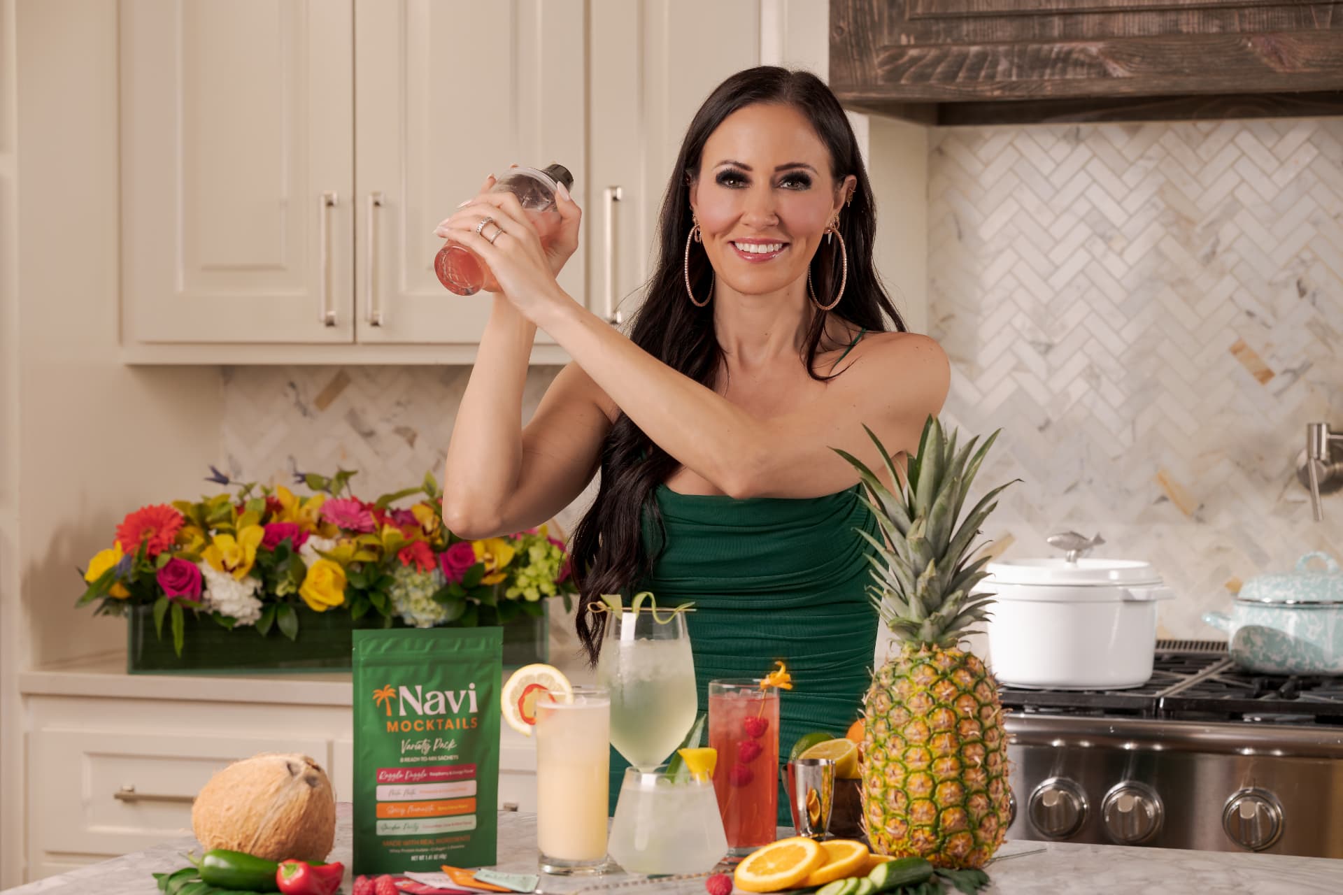 Emily shaking a Navi mocktail in a glass shaker