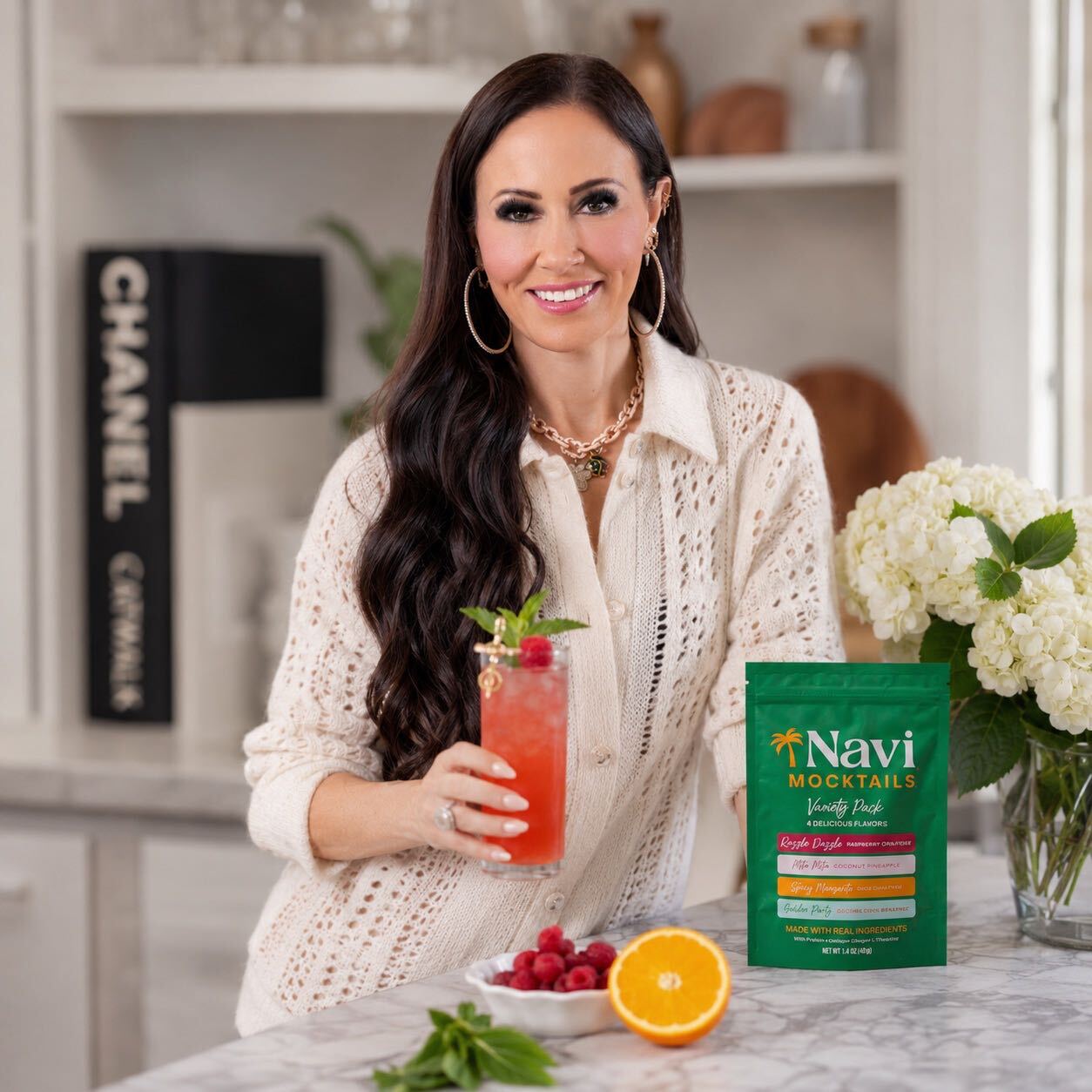Emily holding a Navi mocktail with the Variety Pack