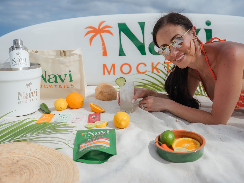 Navi Mocktails beach setup with founder and product lineup