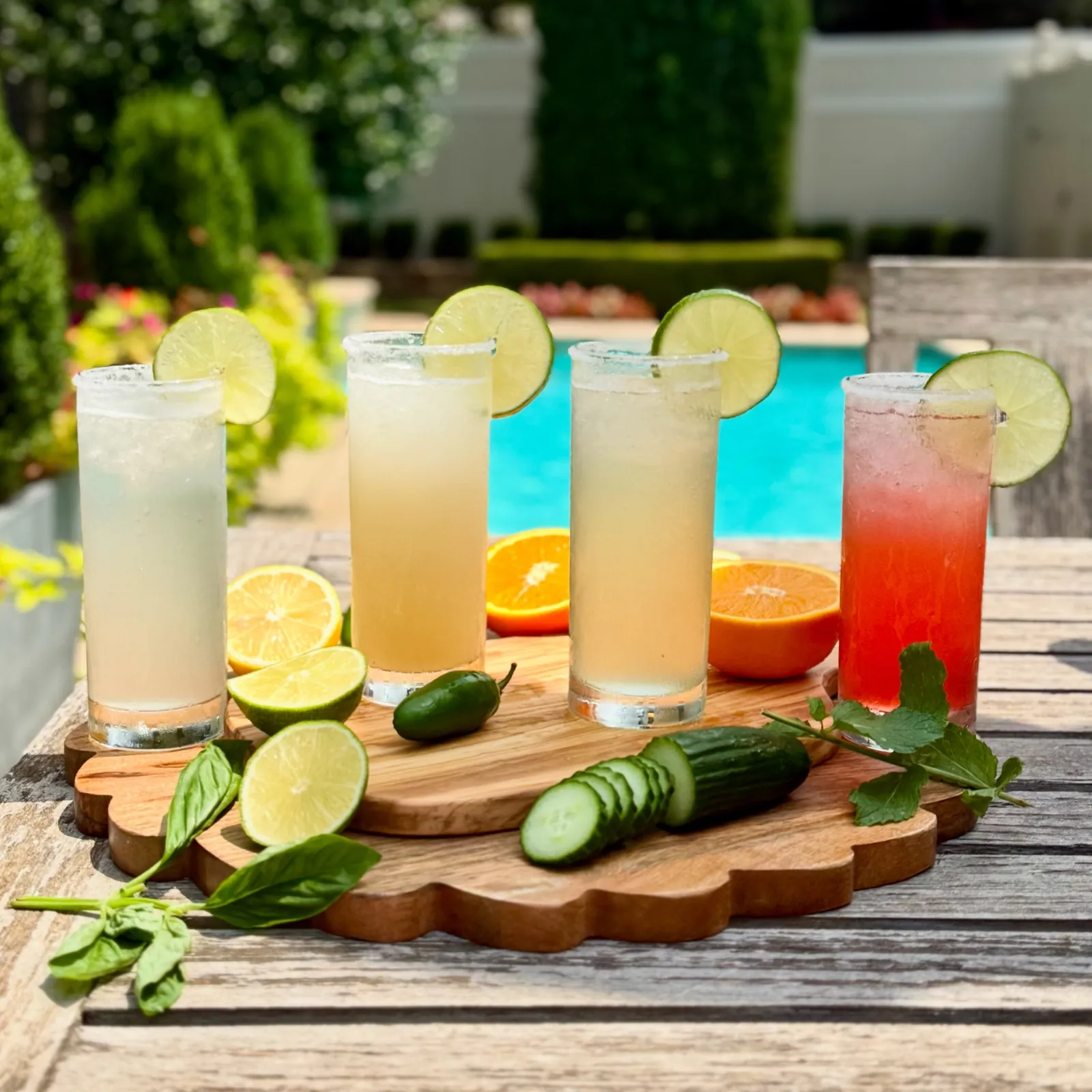 Four Navi mocktails poolside with fresh citrus and herbs
